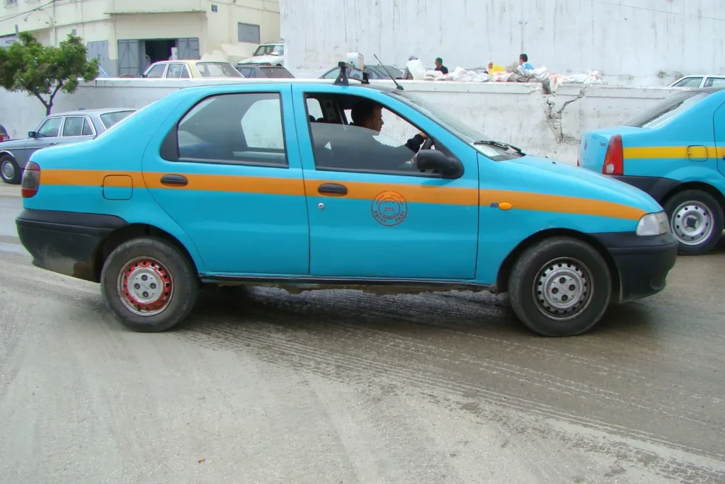 Blue petit taxi in Tangier, one of the vehicles you share the road with when driving in Tangier